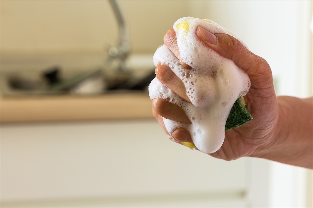 Clean water squeezed from a sponge illustrating soft water without a slimy feel